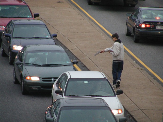 Caleb Green passing out literature in traffic.