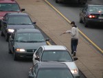 Caleb Green passing out literature in traffic.