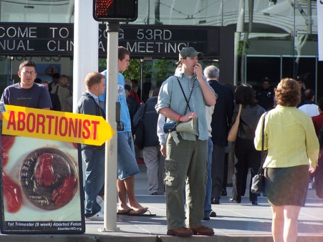 Michael Marcavage preaches to the doctors and abortionists passing by.