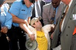 Police arrest and carry Michael Marcavage to an awaiting patty wagon.