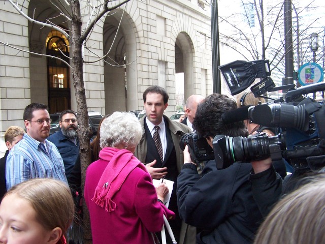 Media gathers for interviews after the dismissal of the charges.