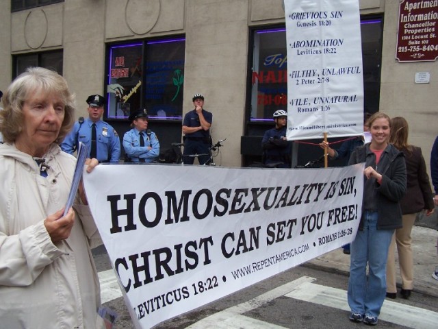 Linda and Talitha hold sign.