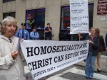Linda and Talitha hold sign.