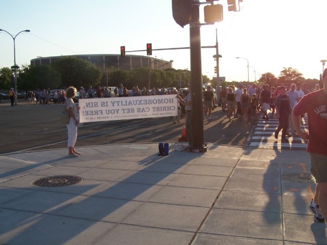 Second angle of crowd passing by banner.