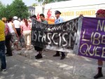 Members of a milatant homosexual group holding sign.