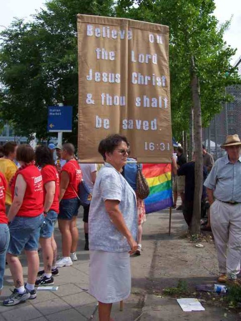 Nancy Major holding a Gospel banner.