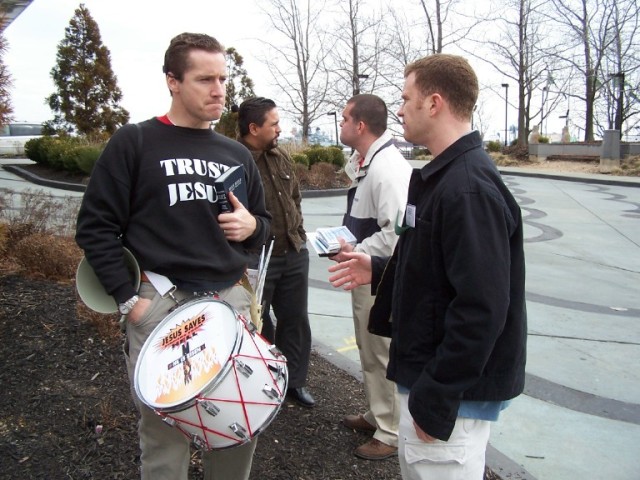 Mark Diener and Tim Gruber share the Gospel with different atheists outside the Hyatt Regency hotel. (Mark left front, Tim right back)