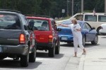 Linda Beckman hands out tracts in traffic.