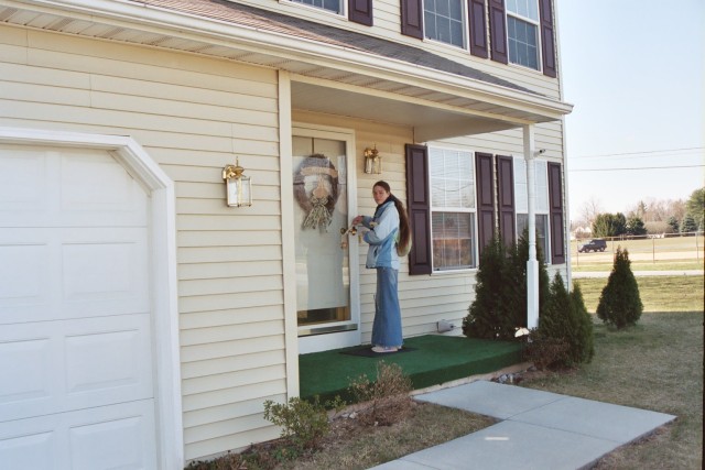 Caitlin distributing invitations and tracts door-to-door
