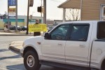 Truck passes by sign