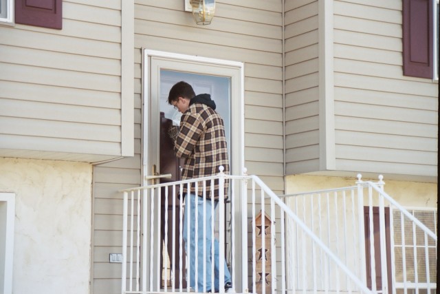 Jadan distributing invitations and tracts door-to-door
