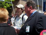 Captain Fisher (right) guards the preaching of the Word of God during Equality Forum.