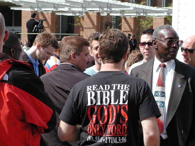 Mark Diener witnesses to homosexuals through a wall of police officers.