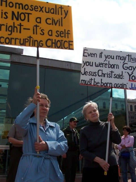Faith Deferio (left) and Betty Hoffman (right) hold signs at Independence Hall.