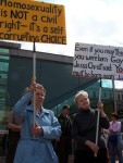 Faith Deferio (left) and Betty Hoffman (right) hold signs at Independence Hall.